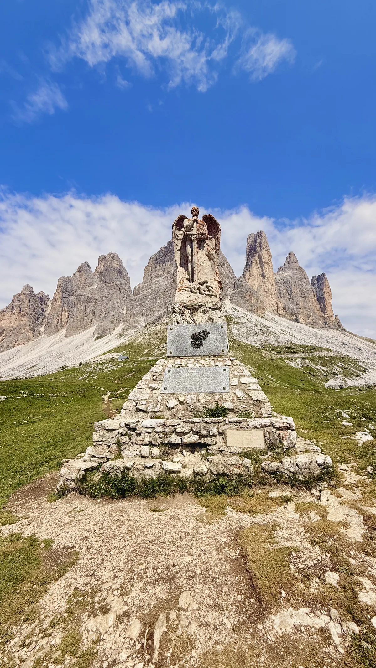 Monument to the Bersaglieri with Tre Cime di Lavaredo in the background, in the Dolomites
