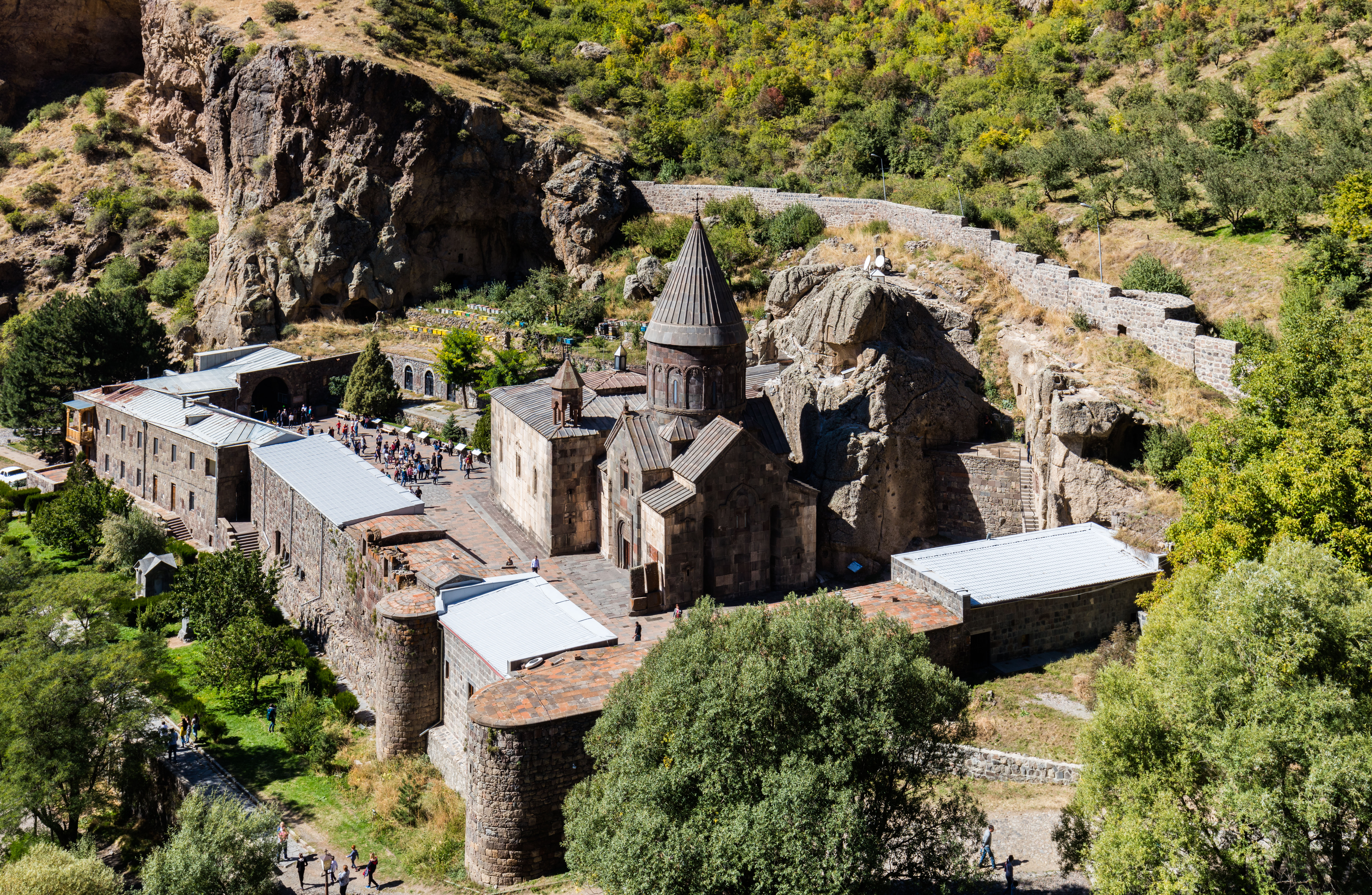 Geghard Monastery partially carved into the rock with mountains around it, Kotayk region, Armenia