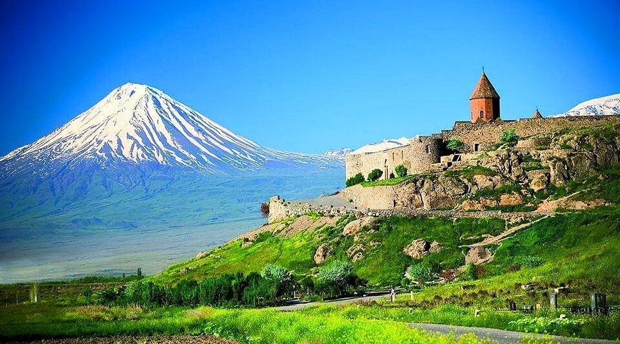 Khor Virap Monastery with the snowy Mount Ararat in the background under a blue sky, Ararat Plain, Armenia