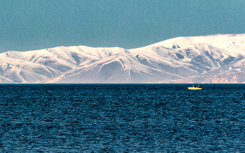 Lake Sevan with blue waters and mountains around it under an open sky, Gegharkunik region, Armenia