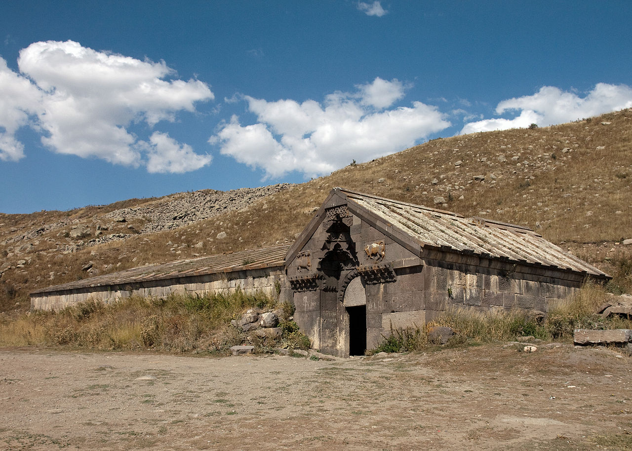 Orbelian Caravanserai with preserved stone walls and medieval arches on a high plateau, Armenia