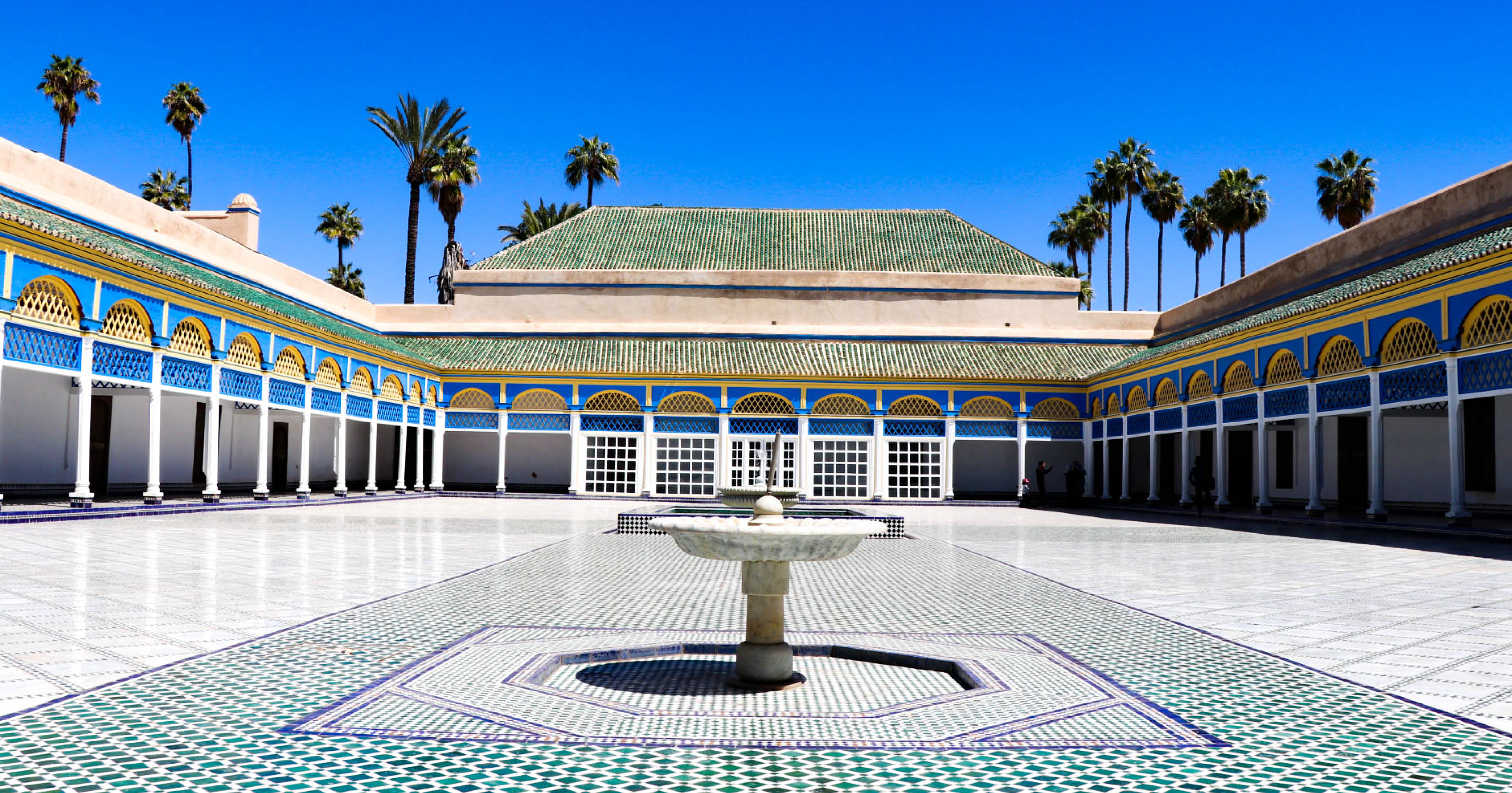 Pátio interno do Palácio Bahia em Marrakech com azulejos, fontes e jardins tradicionais marroquinos