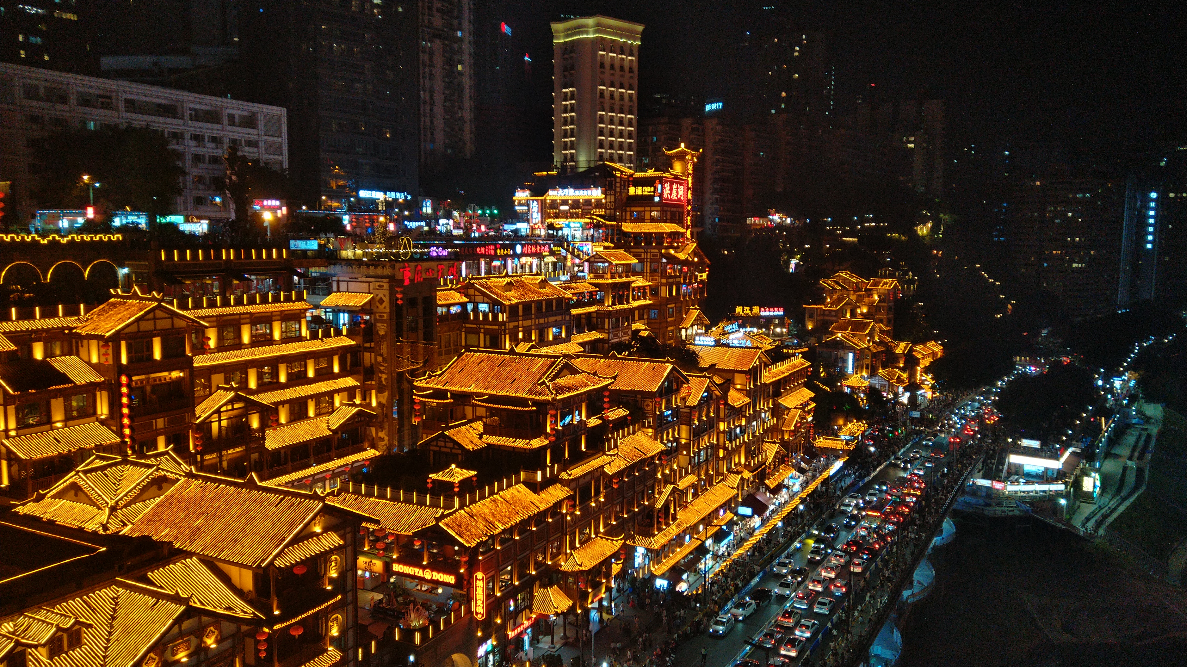 Hongya Cave illuminated at night seen from Qiansimen Bridge in Chongqing
