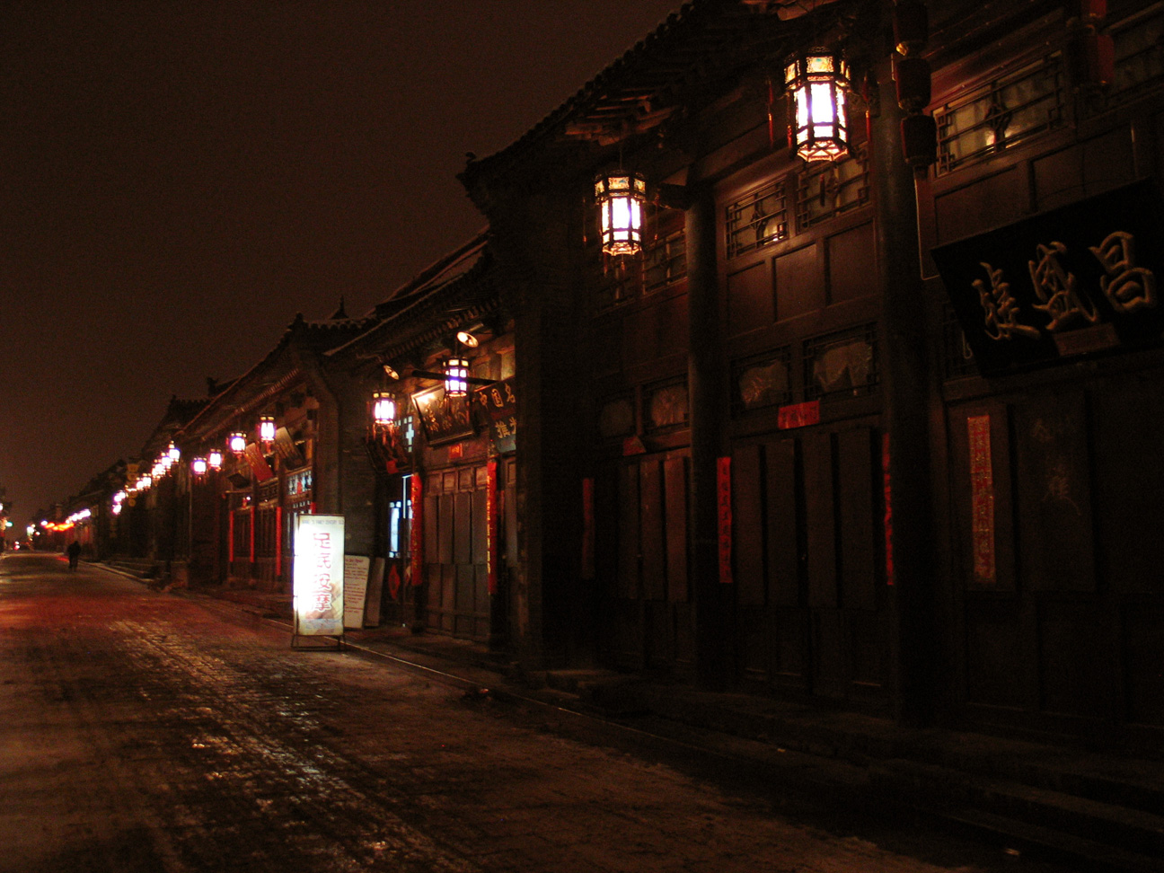 Rua principal de Pingyao à noite iluminada por lanternas vermelhas tradicionais em Shanxi, China